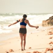 healthy woman walking on beach